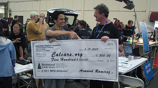 Armand Ramirez, a generous CalCars donor, handing Felix a $500 check in May 2007